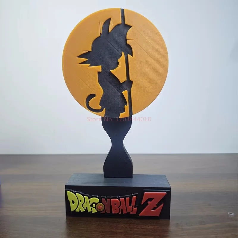 Soporte para auriculares negro Dragon Ball - silueta de Goku delante de un disco naranja