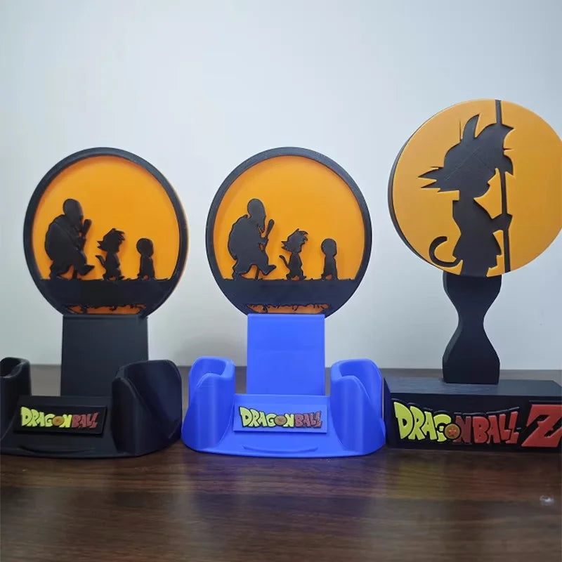 Soporte para auriculares negro Dragon Ball - silueta de Goku delante de un disco naranja