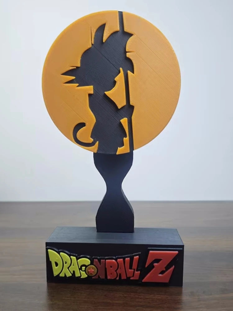 Soporte para auriculares negro Dragon Ball - silueta de Goku delante de un disco naranja